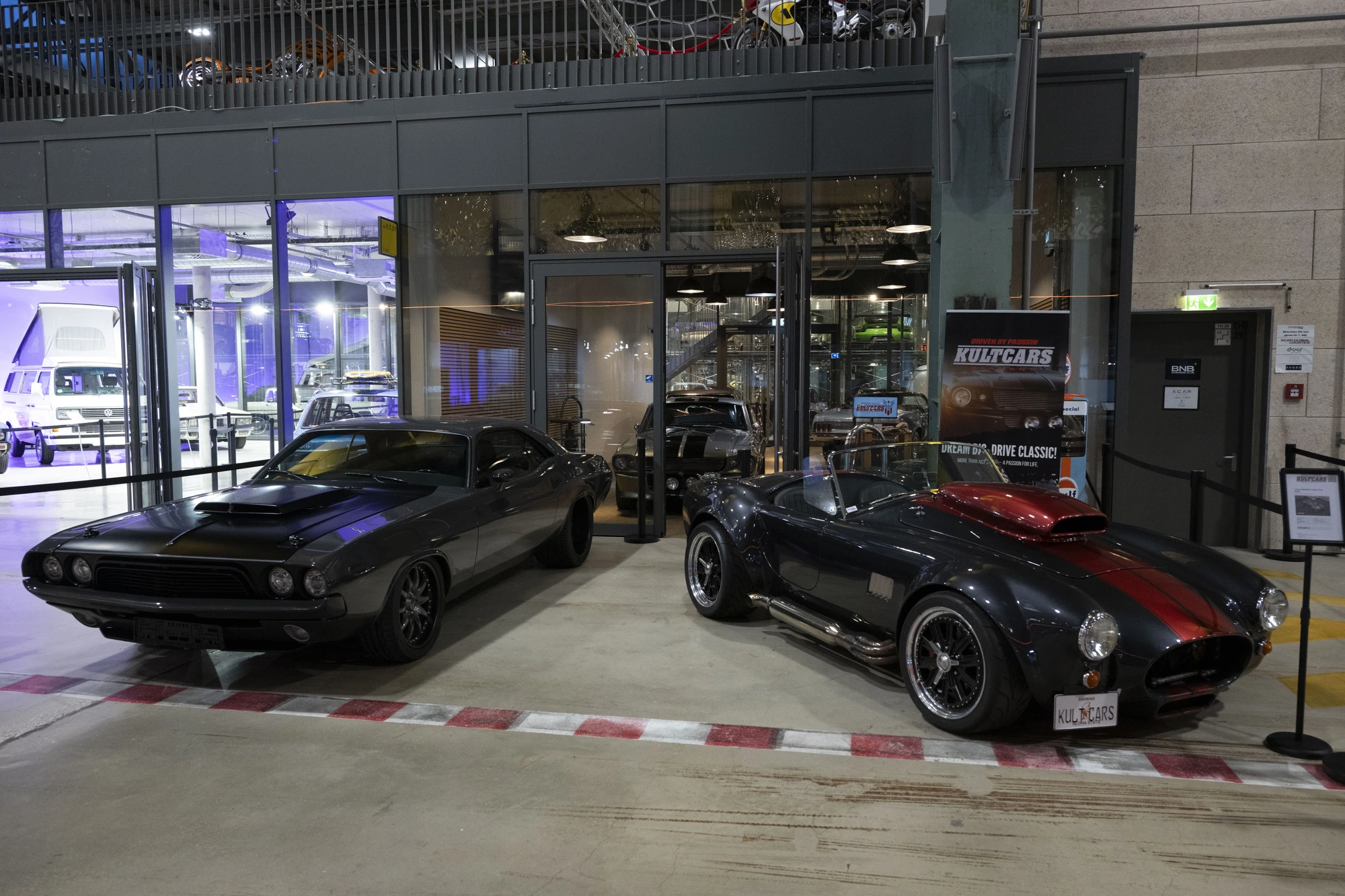 KULT CARS Store in der Motorworld München mit Dodge Challenger und Shelby Cobra davor